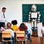 Smiling school teacher in classroom with children and robot